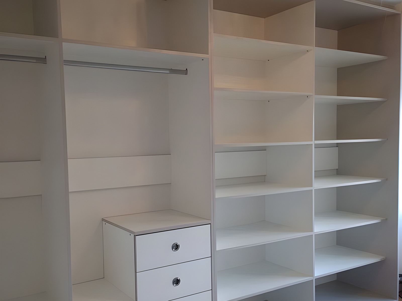 Fitted wardrobe interior with hanging rails, shelving and drawer unit